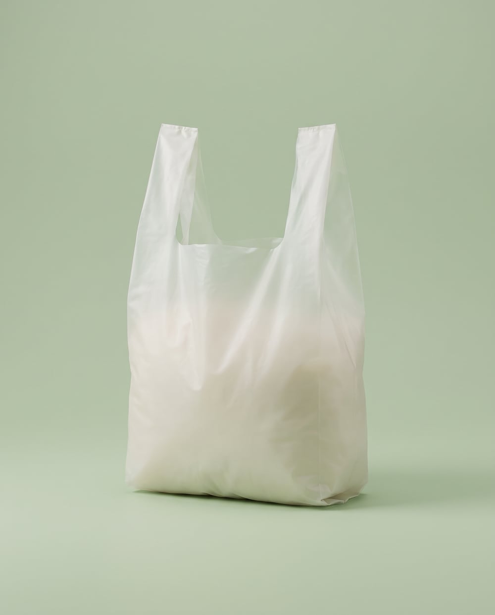 Milky white translucent compostable vest carrier bag with integrated vest handles