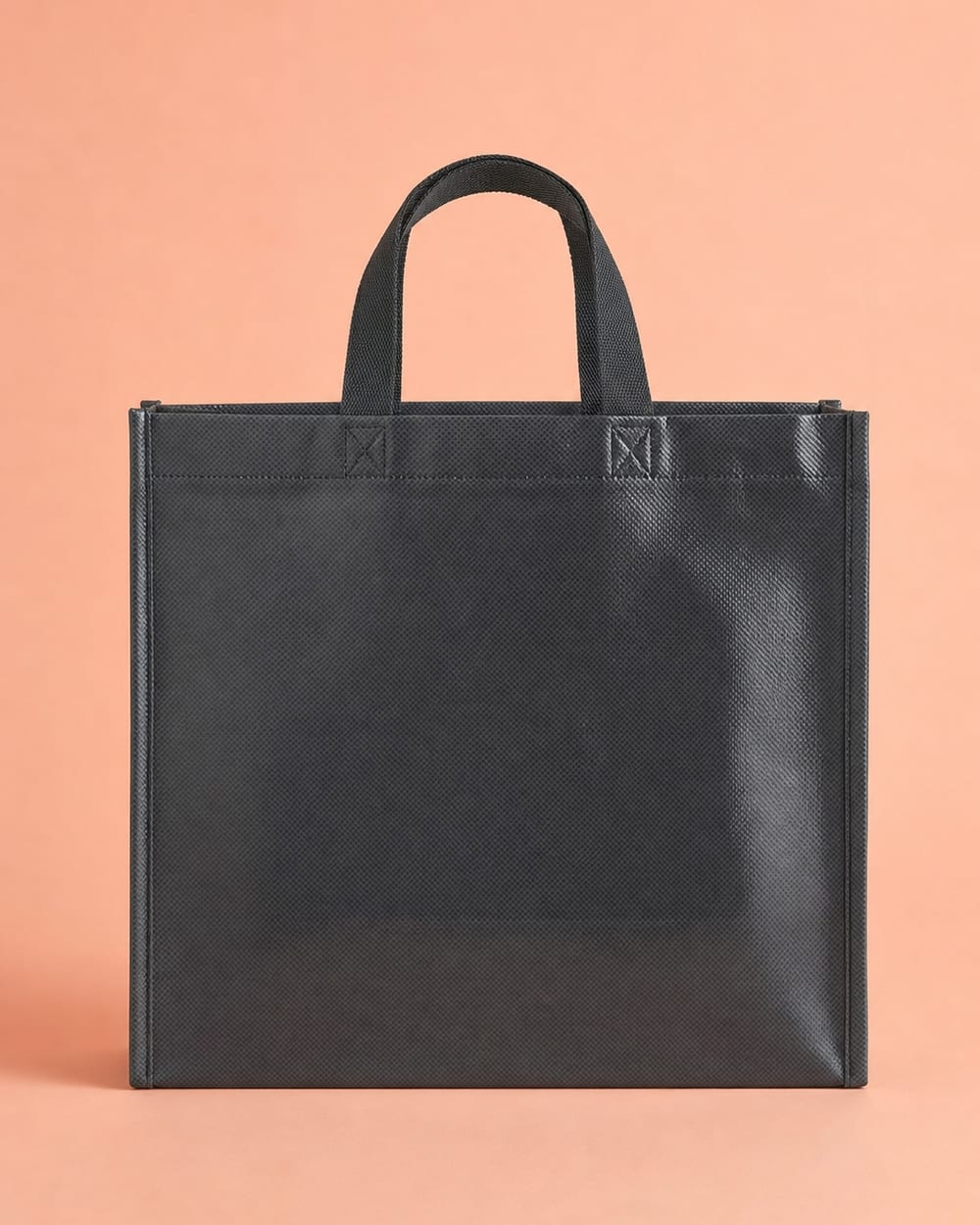 Charcoal non-woven bag with gloss lamination and short heat-sealed tape handles
