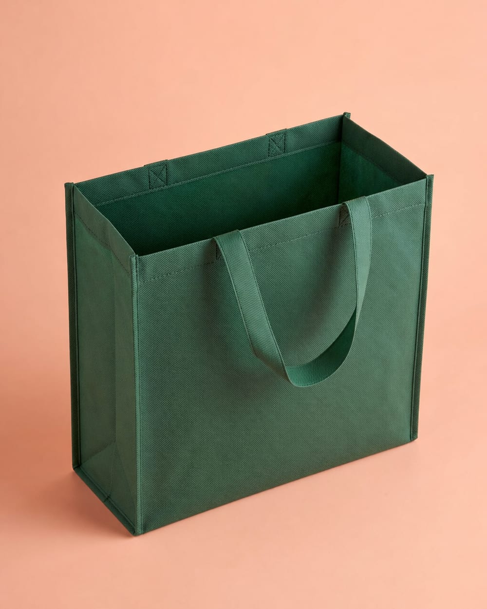 Green non-woven bag with no lamination, open at the top, with heat-sealed tape handles