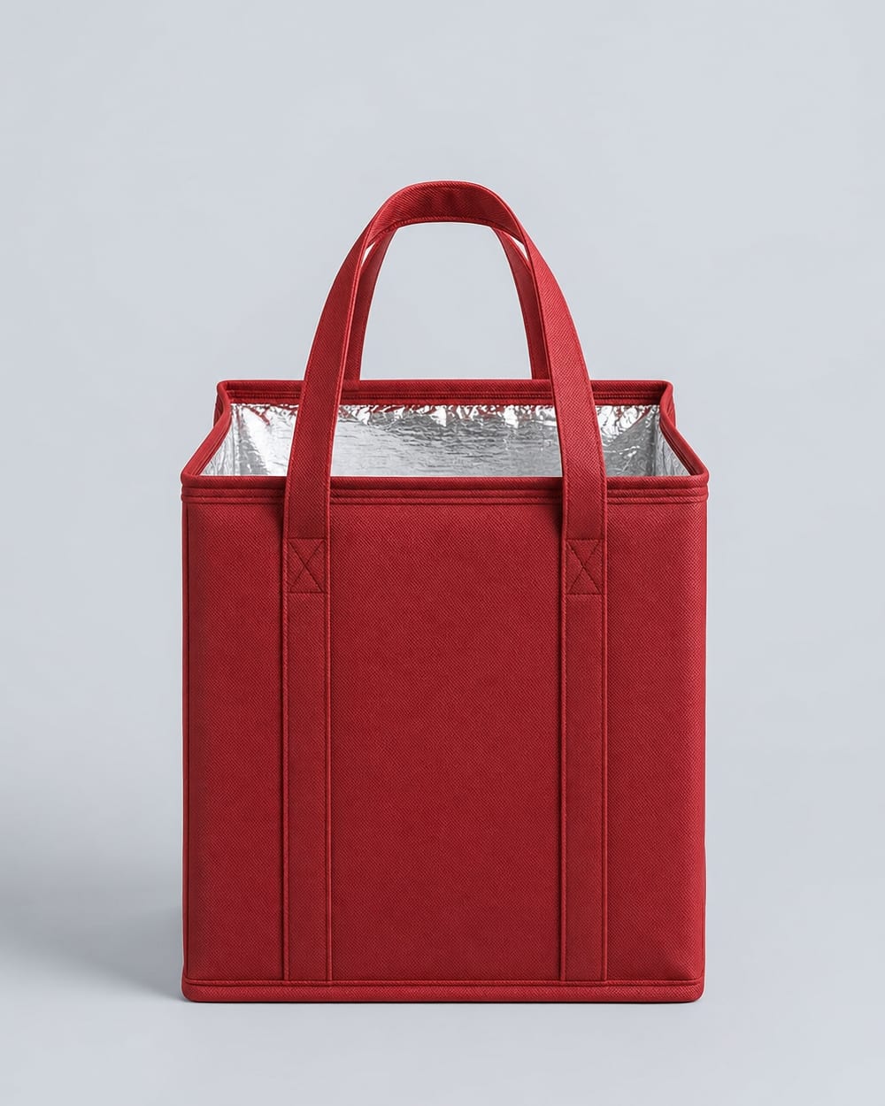 Red thermal delivery bag, open at the top, showing the foil lining