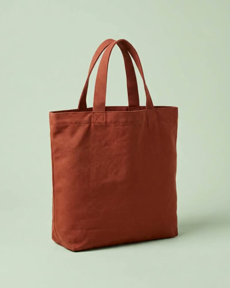 Rust dyed cotton tote with short sewn tape handles